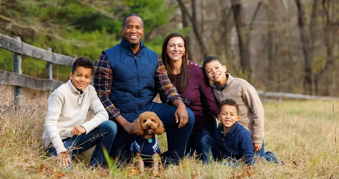 John James with his wife, their three sons and the family dog in a Michigan field