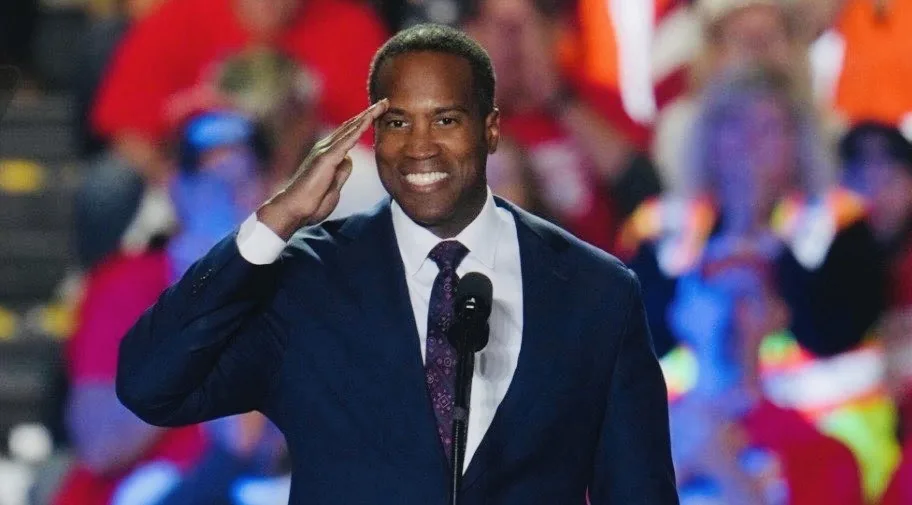 John James saluting at a campaign event