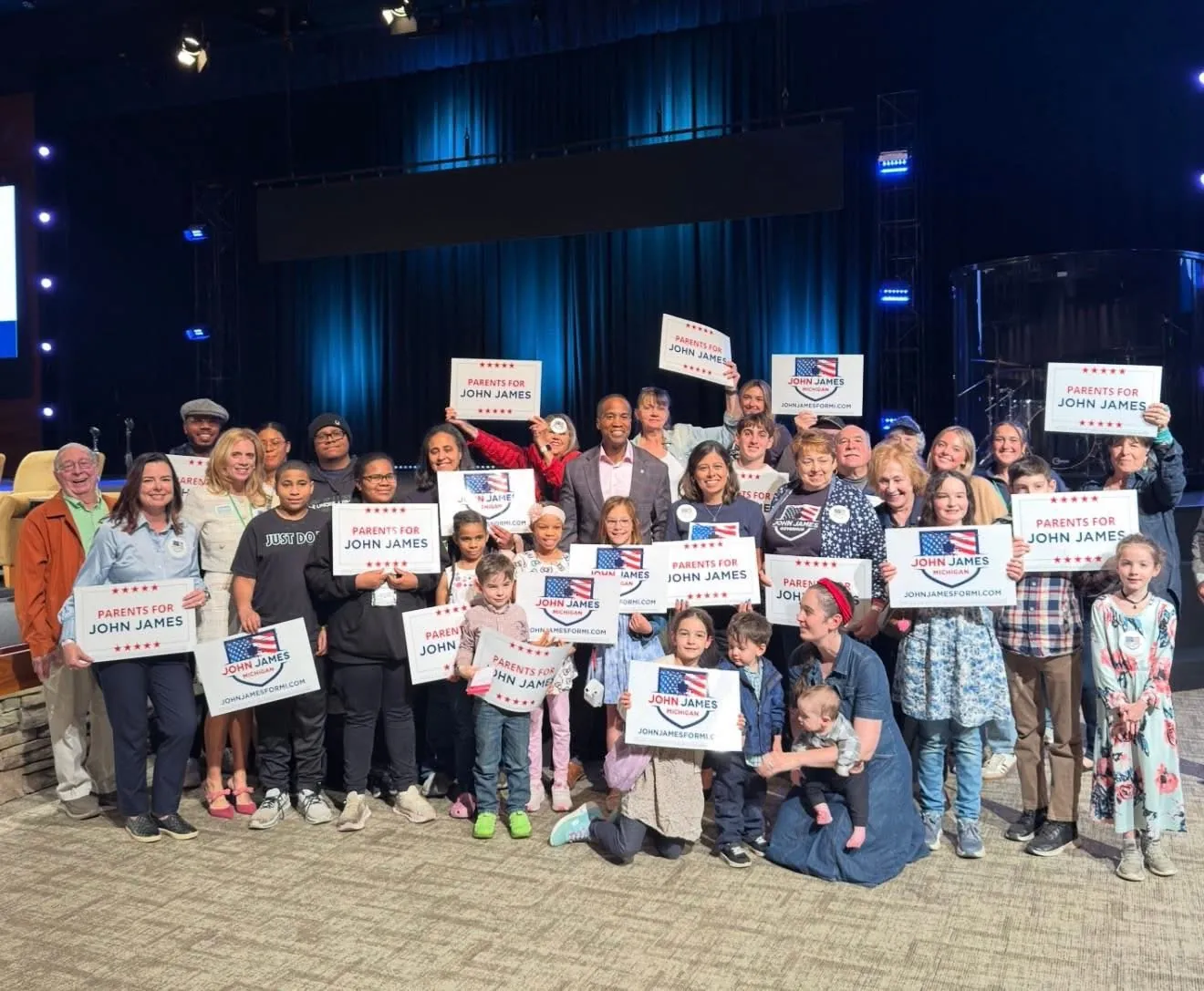 Parents and kids holding Parents for John James signs